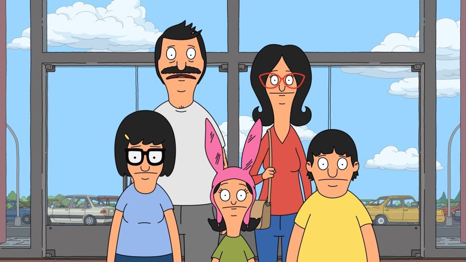 Bob, Linda, Tina, Louise, and Gene from Bob’s Burgers stand in front of a window, smiling
