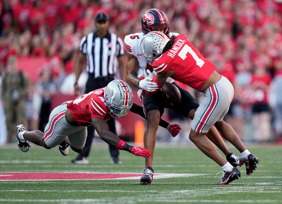 Ohio State cornerback Jordan Hancock (7) forces Western Kentucky wide receiver Blue Smith to fumble the ball.