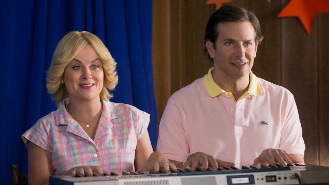 The whole gang is back! To kick off summer, Netflix debuted brand new images from the upcoming <em>Wet Hot American Summer</em> prequel series, <em>First Day of Camp</em>. And everyone looks absolutely amazing as they settle back into the teenage characters they once played in their 30s even though they’re now in their 40s. <strong>NEWS: Netflix's 'Wet Hot American Summer' Cast by the Numbers</strong> Among the new images are first looks at Amy Poehler, Bradley Cooper, Christopher Meloni, Janeane Garofalo, Molly Shannon, and the punkiest teen of them all, Paul Rudd. Elizabeth Banks is Lindsay, who famously tasted "like a burger." Netflix Rudd and Marguerite Moreau reunite as Andy and Katie. Netflix Joe Lo Truglio and Ken Marino look perfect in their wigs. ETONLINE Meloni does the splits as crazy Gene. ETONLINE Shannon is flanked by Nina Hellman and Judah Friedlander. Netflix Garofalo with a can of vegetables (voiced by H. Jon Benjamin). Netflix And the rest of the gang (Zak Orth, Michael Showalter, Marino, Truglio, and Hellman). Netflix It’s almost like we never left Camp Firewood. <em>Wet Hot American Summer: First Day of Camp</em> will consist of eight half-hour episodes, which will premiere on July 31. 