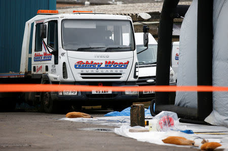 Police tape and bagged items are seen near an inflatable structure in the courtyard of Ashley Wood Recovery; where emergency services worked following the poisoning of former Russian intelligence officer Sergei Skripal and his daughter Yulia; in Salisbury, Britain March 14, 2018. REUTERS/Henry Nicholls