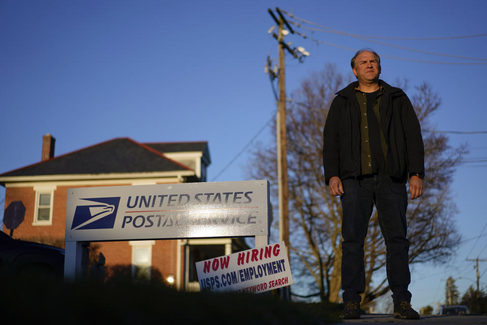 Gerald Groff, a former postal worker whose case will be argued before the Supreme Court, stands during a television interview near a "Now Hiring" sign posted at the roadside at the United State Postal Service, Wednesday, March 8, 2023, in Quarryville, Pa. (AP Photo/Carolyn Kaster)