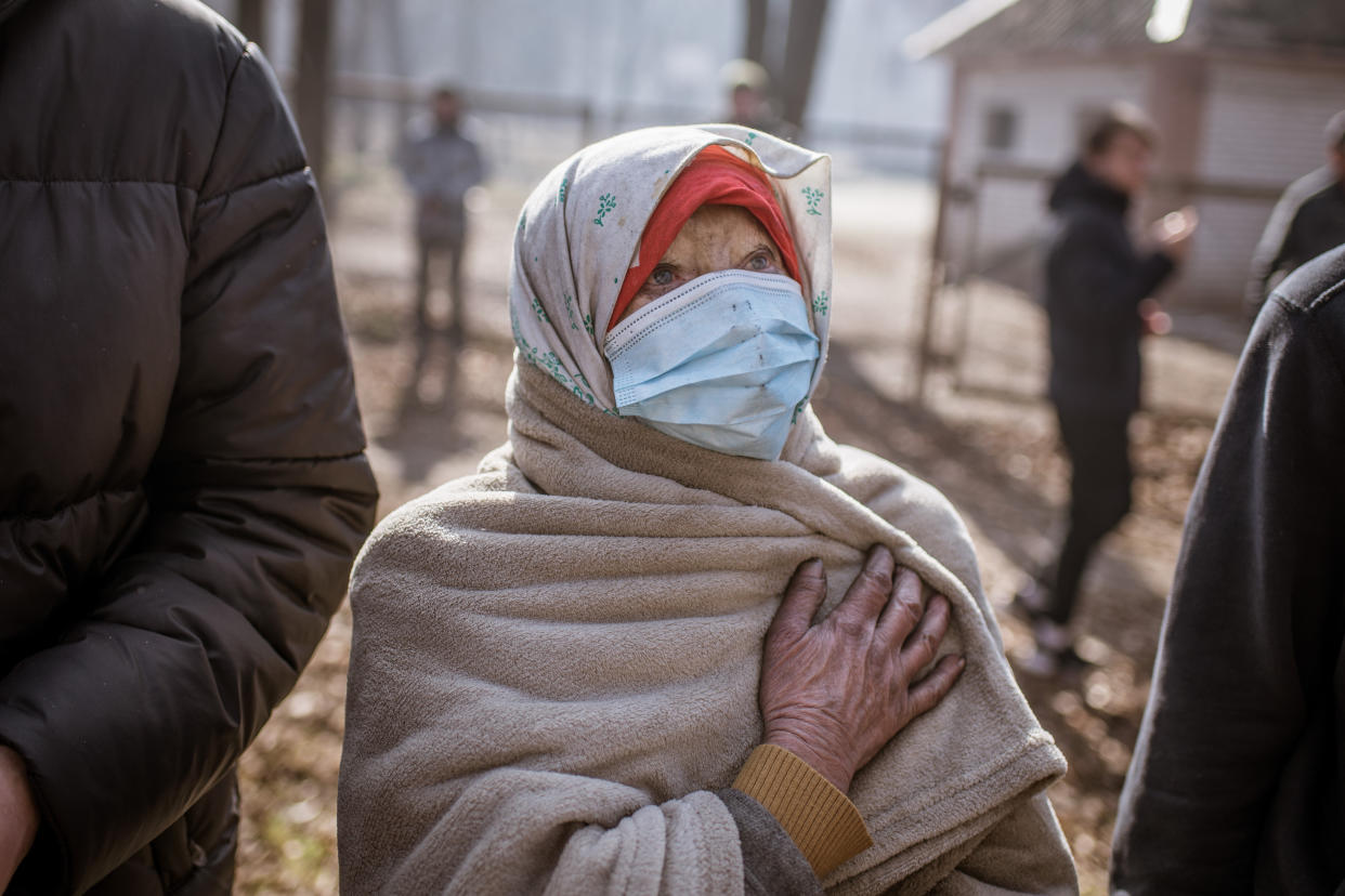 KYIV, UKRAINE - MARCH 15: An old woman views the damage after a shelling hit a building on Chronobylska street in Svyatoshynski district in Kyiv, Ukraine on March 15, 2022 as Russian attacks continue. (Photo by Andre Luis Alves/Anadolu Agency via Getty Images)