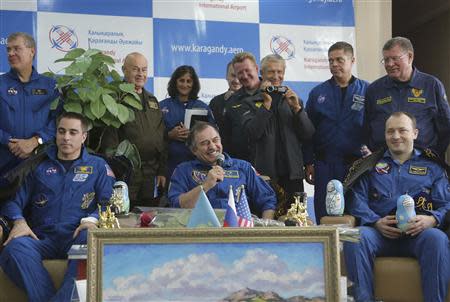 Russian cosmonauts Alexander Misurkin (R) and Pavel Vinogradov (C) and US astronaut Chris Cassidy (L) attend a press conference at the airport in Karaganda, Kazakhstan, September 11, 2013. REUTERS/Maxim Shipenkov/Pool