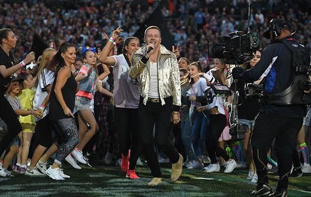 On Sunday Macklemore took to stage at the NRL grand final, despite there having been a petition to ban him from performing at the sporting event. Source: AAP