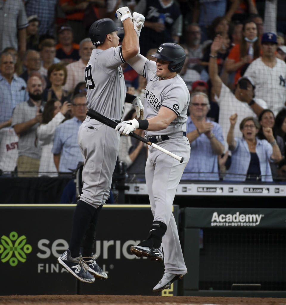 New York Yankees' Aaron Judge, left, celebrates his solo home run with Luke Voit during the third inning of a baseball game against the Houston Astros, Saturday, July 10, 2021, in Houston. (AP Photo/Eric Christian Smith)