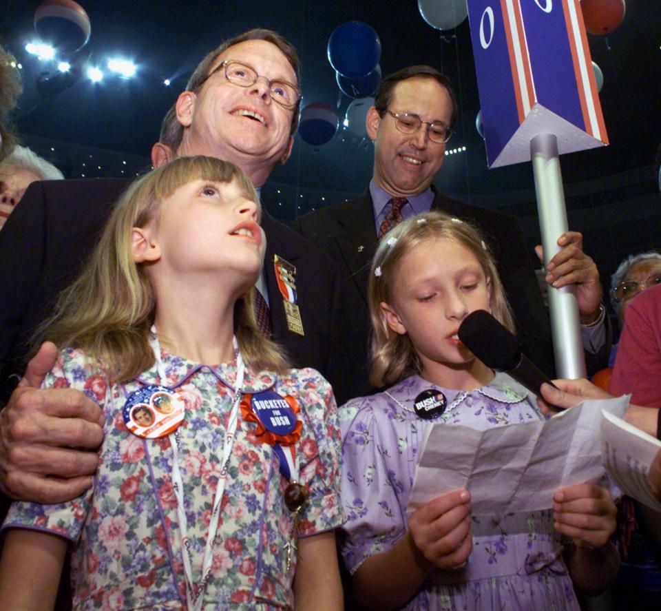 Rick Colby's son Ashton Colby (right), then a third-grader from Dublin known as Ashley, announced that the State of Ohio passed the roll call vote to nominate George W. Bush as the party's presidential candidate, at the Republican Convention in Philadelphia, Aug. 2, 2000. Next to Colby is Anna DeWine. Behind Colby are Sen. Mike DeWine, R-Ohio, and Gov. Bob Taft, right. (AP Photo/Amy Sancetta).