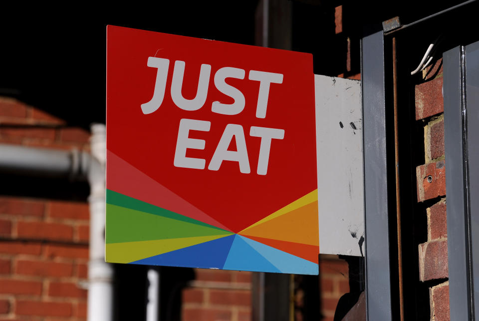 FLEET, ENGLAND - MAY 19: A detailed view of a Just Eat sign displayed at the front of a pizza takeaway shop on May 19, 2020 in Fleet, England. The British government has started easing the lockdown it imposed two months ago to curb the spread of Covid-19, abandoning its 'stay at home' slogan in favour of a message to 'be alert', but UK countries have varied in their approaches to relaxing quarantine measures. (Photo by Alex Burstow/Getty Images)