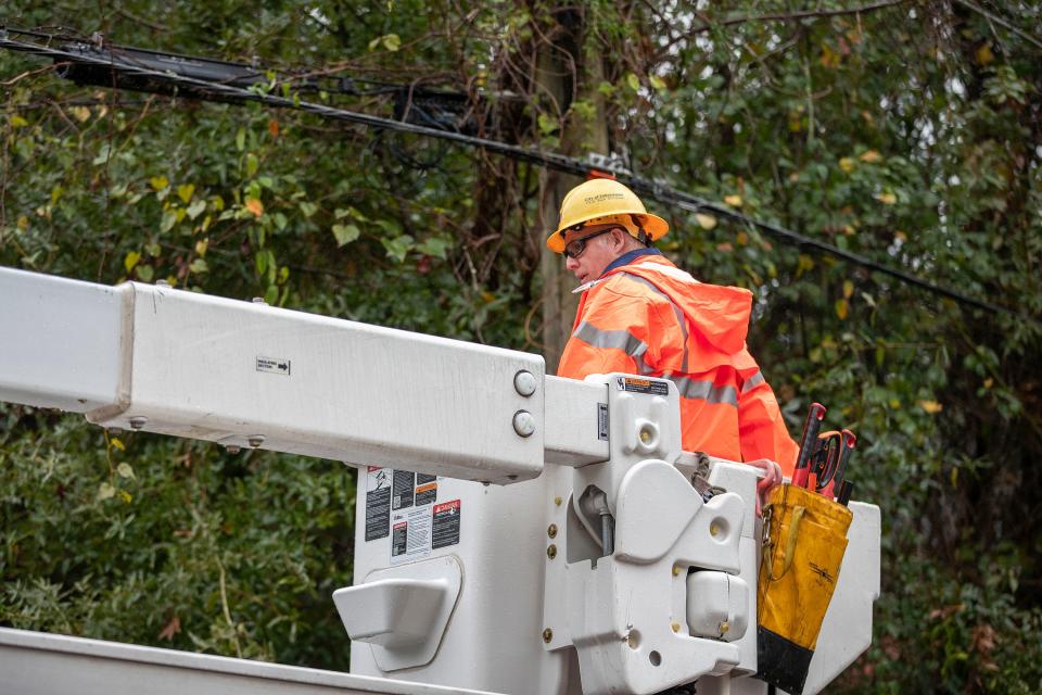 A city utilities worker clears a power line Thursday, Nov. 10, 2022, as Tallahassee feels the effects of Tropical Storm Nicole.