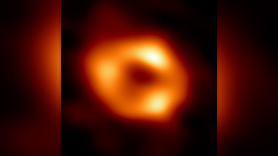 An orange torus shape on a black background