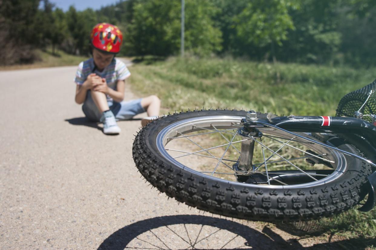 boy is lying hurt after a bicycle accident