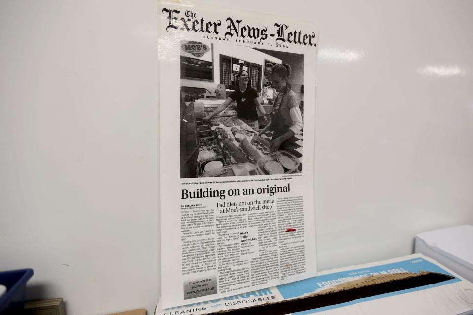 An archived Exeter News-Letter hangs on the wall of Moe’s Italian Sandwiches in Exeter on Feb. 1, 2022.