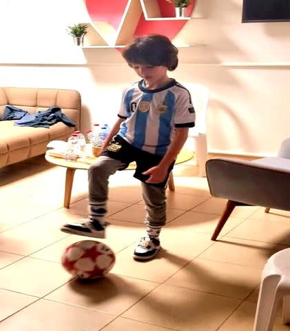 <p>Courtesy of the Haran Family</p> Naveh Shoham, 8, plays with a soccer ball after being released by Hamas.