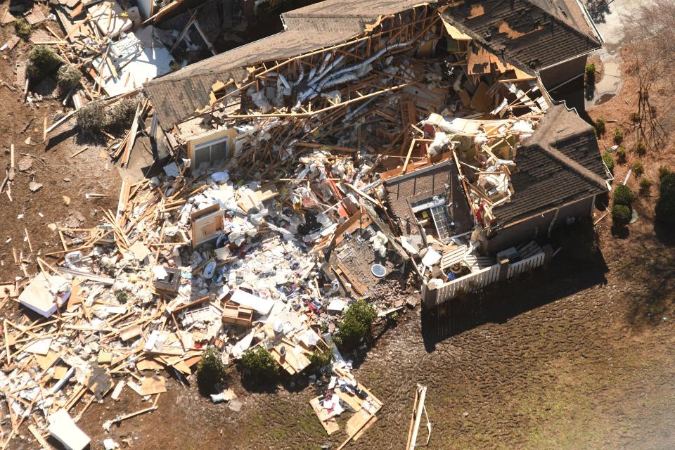 A aerial picture of the tornado hit area shows a house completely damagedAP