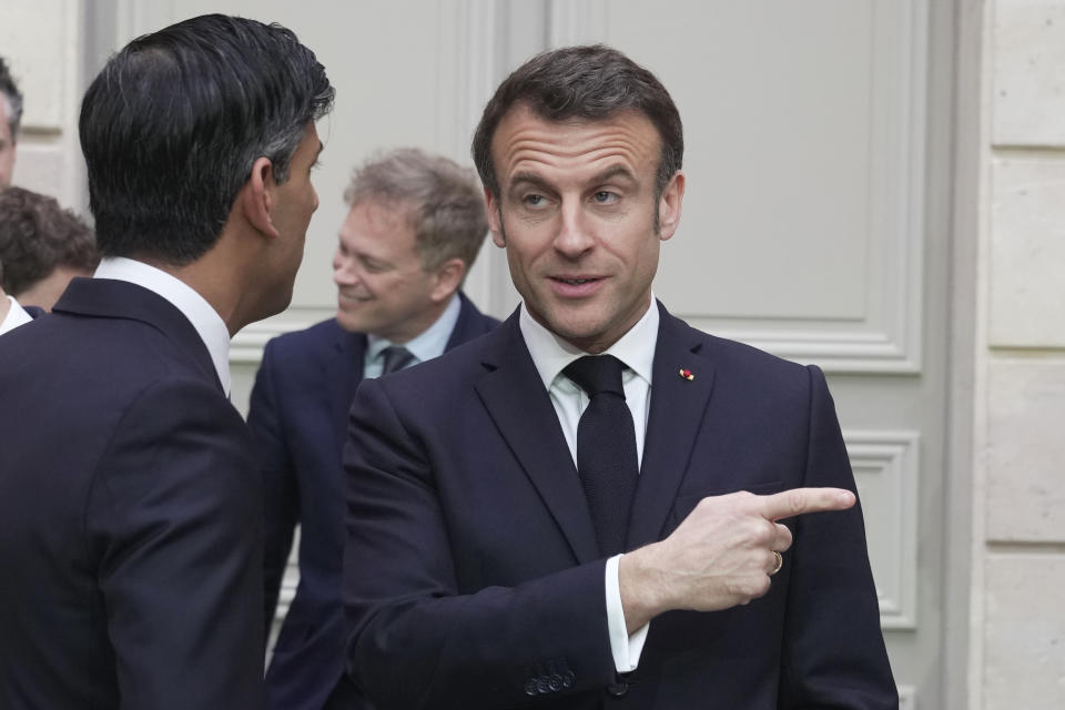 French President Emmanuel Macron, right, and Britain's Prime Minister Rishi Sunak talk after a group picture with ministers during a French-British summit at the Elysee Palace in Paris, Friday, March 10, 2023. French President Emmanuel Macron and British Prime Minister Rishi Sunak meet for a summit aimed at mending relations following post-Brexit tensions, as well as improving military and business ties and toughening efforts against Channel migrant crossings. (AP Photo/Kin Cheung, Pool)
