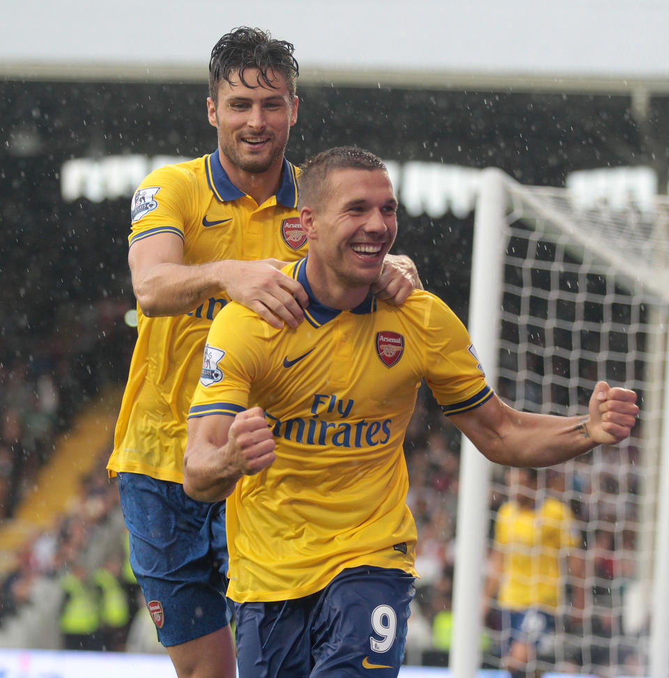 Arsenal's Lukas Podolski celebrates his second goal during the Barclays Premier League match at Craven Cottage, London.