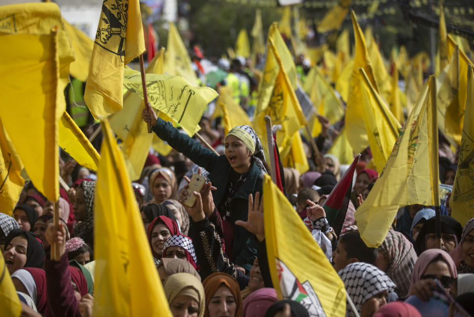 Palestinians wave yellow Fatah flags during a rally marking the 55th anniversary of the Fatah movement founding, in Gaza City, Wednesday, Jan. 1, 2020. Fatah is a secular Palestinian party and former guerrilla movement founded by the late Palestinian leader Yasser Arafat. (AP Photo/Khalil Hamra)