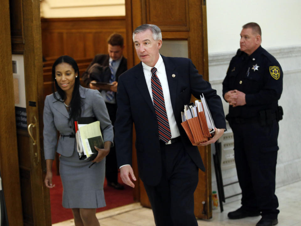 FILE-This Wednesday, Feb. 3, 2016 file photo shows Montgomery County District Attorney, Kevin Steele, right, and Asst. DA Kristen Feden, left, leave the courtroom during lunch break at the pre-trial hearing for entertainer Bill Cosby and his sexual assault case in Norristown, Pa. Steele, the lead prosecutor in Cosby's sex assault case believes the Pennsylvania Supreme Court overstepped its power in reversing the comedian's conviction and added "fuel on the fire' when the chief judge gave a weekend television interview, and appeared to misstate the key issue in the appeal. Chief Judge Max Baer accused prosecutors of a "reprehensible bait and switch" in arresting Cosby in 2015 despite what he called the certain existence of a 2005 non-prosecution agreement. (Michael Bryant/The Philadelphia Inquirer via AP, Pool, File)