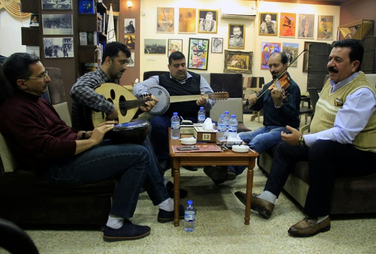 Iraqi musicians perform at a book fair in Mosul on November 6, 2018