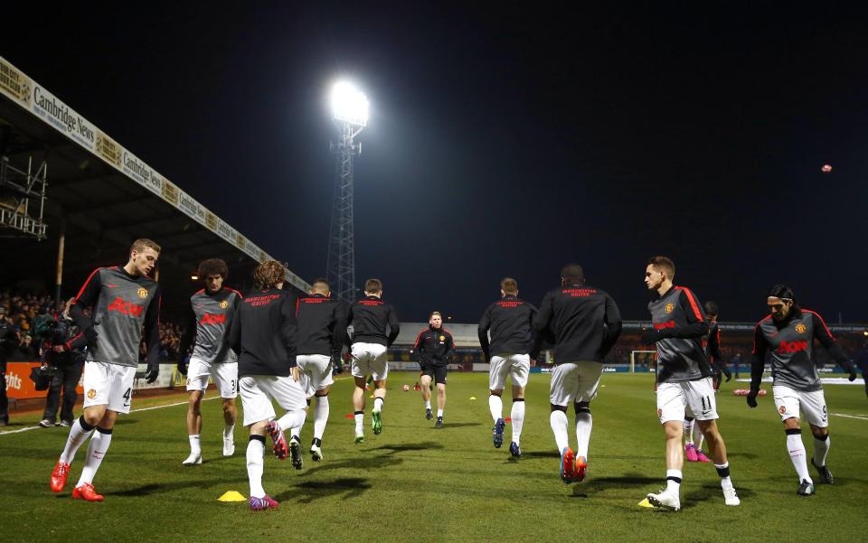 Manchester United players warm up before their English FA Cup 4th round soccer match against Cambridge United at The Abbey Stadium in Cambridge, eastern England January 23, 2015. REUTERS/Andrew Winning (BRITAIN - Tags: SPORT SOCCER)