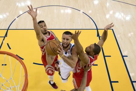 May 20, 2018; Oakland, CA, USA; Golden State Warriors guard Stephen Curry (30) shoots the basketball against Houston Rockets guard Gerald Green (14) and guard Eric Gordon (10) during the first half in game three of the Western conference finals of the 2018 NBA Playoffs at Oracle Arena. The Warriors defeated the Rockets 126-85. Mandatory Credit: Kyle Terada-USA TODAY Sports