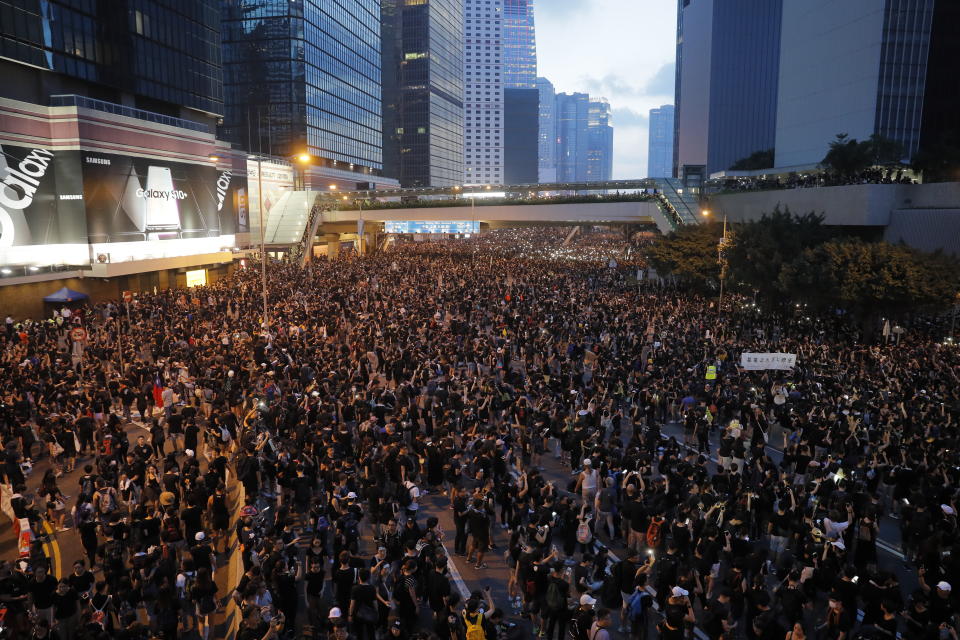 Tens of thousands of protesters march through the streets as they continue to protest an extradition bill, Sunday, June 16, 2019, in Hong Kong. Hong Kong residents Sunday continued their massive protest over an unpopular extradition bill that has highlighted the territory's apprehension about relations with mainland China, a week after the crisis brought as many as 1 million into the streets. (AP Photo/Kin Cheung)