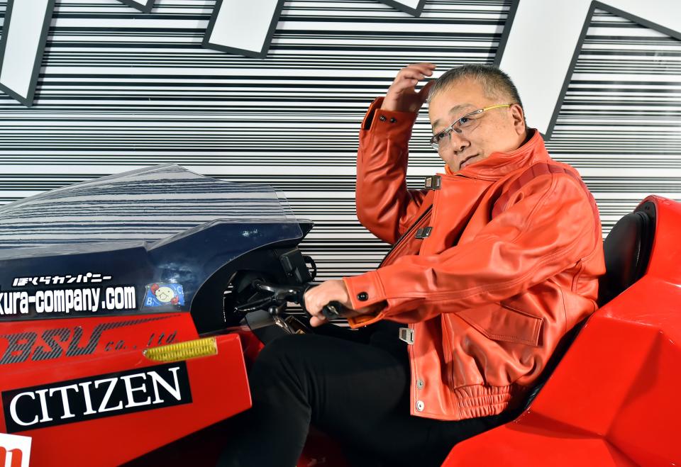 Japanese manga artist Katsuhiro Otomo poses on a replica of his Akira anime's motorbike on the eve of the 43rd Angouleme International Comics Festival on January 27, 2016. (Credit: GEORGES GOBET/AFP/Getty Images)