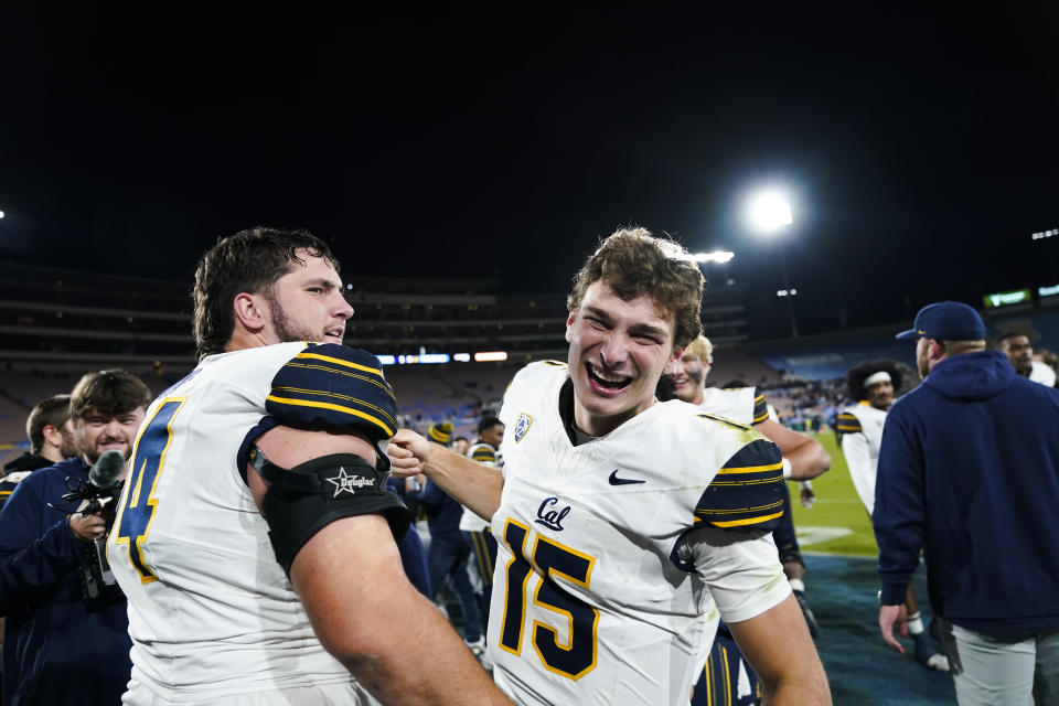 California quarterback Fernando Mendoza, right, celebrates with offensive lineman Matthew Wykoff after the team's 33-7 victory over UCLA in an NCAA college football game Saturday, Nov. 25, 2023, in Pasadena, Calif. (AP Photo/Ryan Sun)