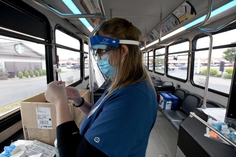 Allie DeVore with Stark County Health Department prepares a shot during a mobile COVID-19 vaccine clinic in the Hartville McDonald's parking lot in June. The health agency, SARTA and the Tom Treyco McDonald's franchise teamed up to offer the clinics.  Tuesday, June 1, 2021.