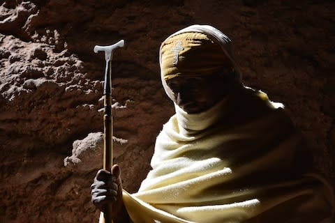 A woman in the shadows of the Church of Saint George, Lalibela - Credit: Hattie Lamb