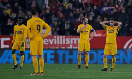 Soccer Football - Spanish King's Cup - Quarter Final Second Leg - Sevilla vs Atletico Madrid - Ramon Sanchez Pizjuan, Seville, Spain - January 23, 2018 Atletico Madrid's Diego Godin and team mates react after conceding their third goal REUTERS/Jon Nazca