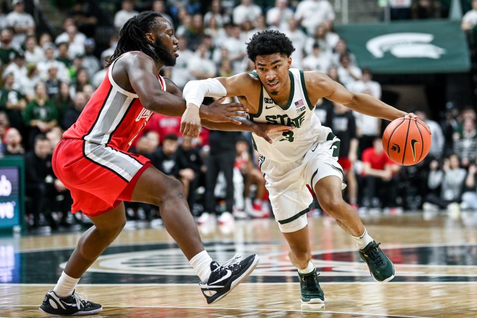 Michigan State's Jaden Akins, right, moves the ball past Ohio State's Bruce Thornton during the second half on Saturday, March 4, 2023, at the Breslin Center in East Lansing.