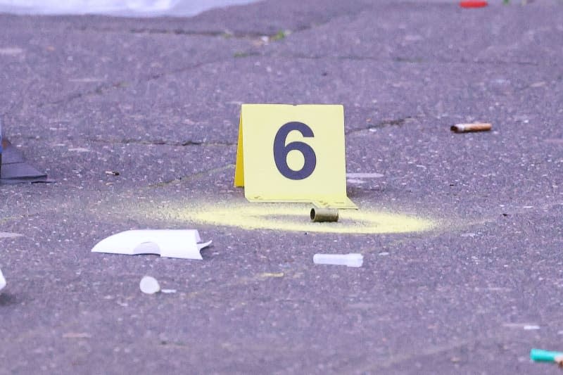 An empty shell casing from a firearm lies on the sidewalk outside a pub in Duesseldorf. One person was killed by gunfire in Duesseldorf on the early hours of 28 April. David Young/dpa