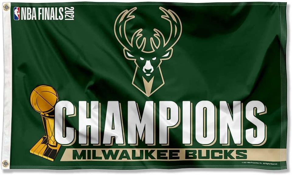 Green flag with Bucks logo and CHAMPIONS written across the front.