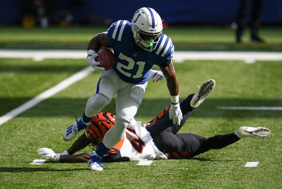 Indianapolis Colts' Nyheim Hines (21) runs past Cincinnati Bengals' Brandon Wilson (40) during the first half of an NFL football game, Sunday, Oct. 18, 2020, in Indianapolis. (AP Photo/Michael Conroy)