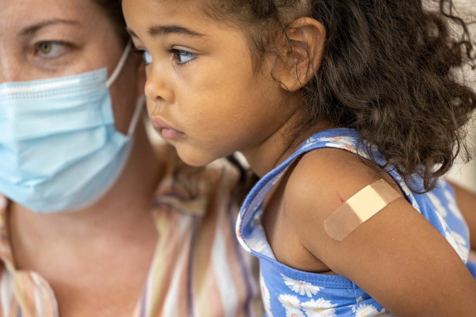 Hazel Harris, 4, sits in the arms of her mom, Heather, after she got her COVID-19 vaccination at Children's Hospital New Orleans, Tuesday, June 21, 2022.