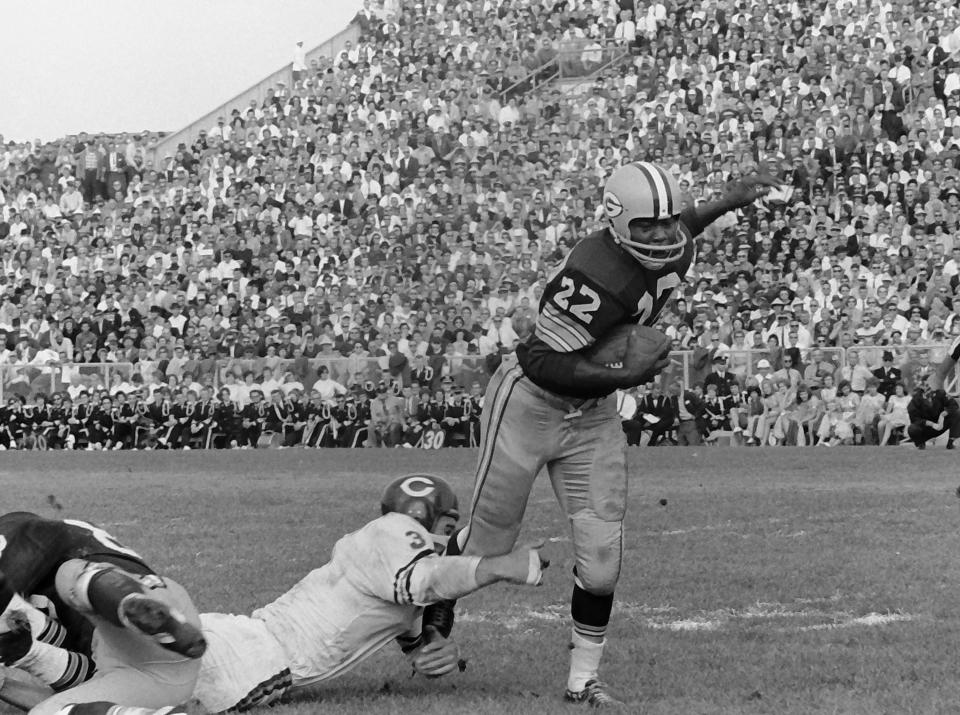 A Chicago Bears player attempts to stop Green Bay Packers running back Elijah Pitts (22). The Packers defeated the Bears 49-0 on Sept. 30, 1962, at New City Stadium, later renamed Lambeau Field, in Green Bay, Wis.