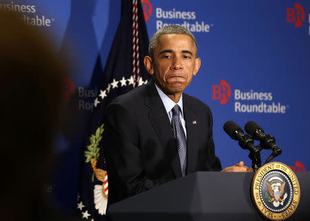 President Obama pauses while he answers questions from business leaders while at the quarterly meeting of the Business roundtable in Washington, December 3, 2014. REUTERS/Larry Downing