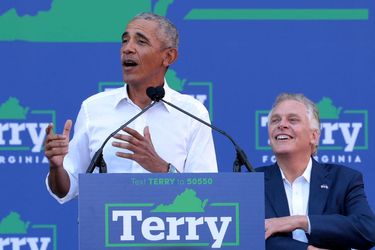 Barack Obama, next to Terry McAuliffe, speaks at a podium with a campaign sign that reads: Text Terry to 50550, Terry