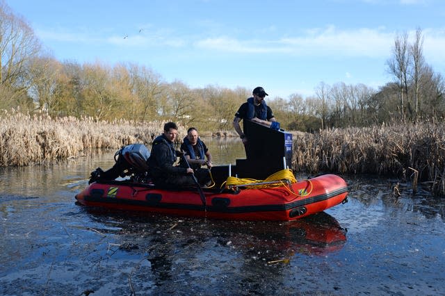 Police officers in an inflatable boat on a lake