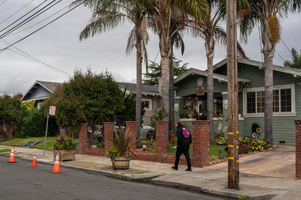 A person walks along a tidy sidewalk.