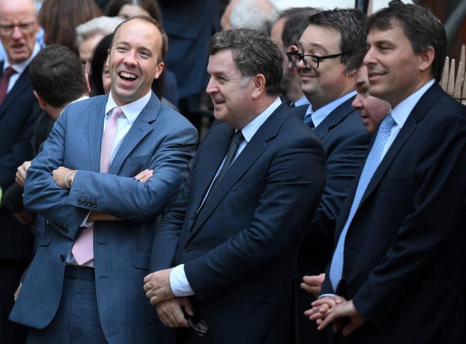 Conservative MP Matt Hancock (L) stands with colleagues outside of Conservative Party headquarters in central London, on October 24, 2022 (Daniel Leal/AFP via Getty Images)