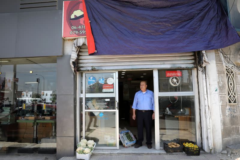 FILE PHOTO: Mohammed Natour waits for customers at his office in Amman