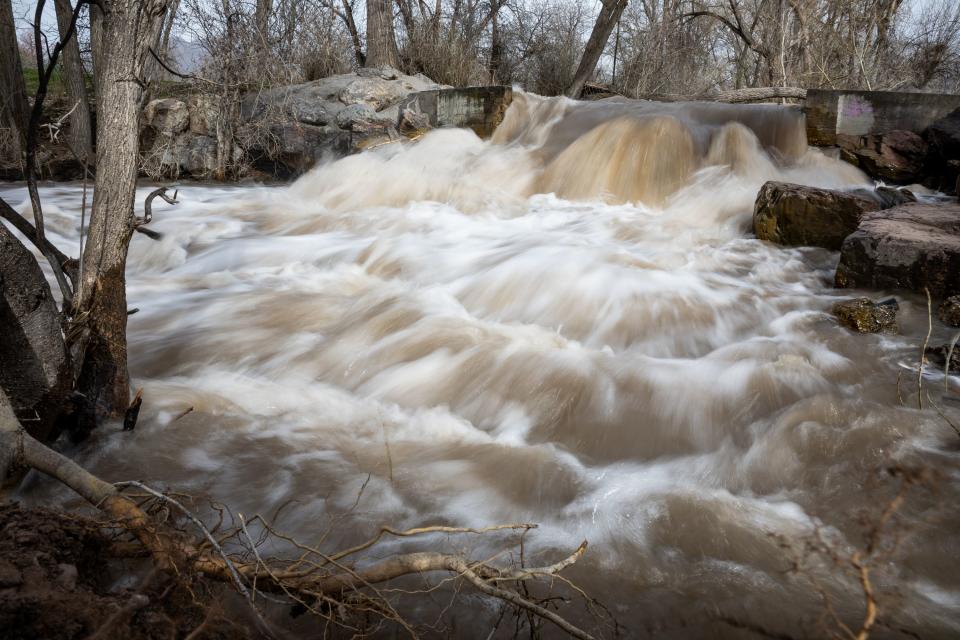 Parleys Creek, swollen by spring snowmelt, surges through Sugar House Park in Salt Lake City on April 12, 2023.