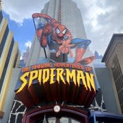 A photo of a humongous Spiderman banner in the front of a building