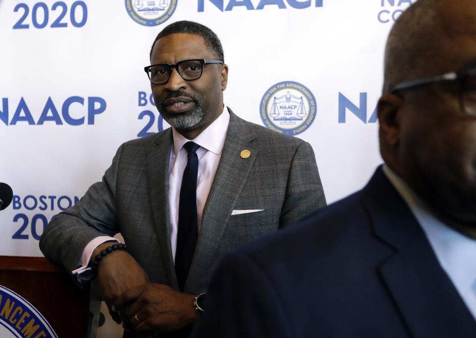 FILE - In this Dec. 12, 2019, file photo National Association for the Advancement of Colored People President Derrick Johnson leans against a podium following a news conference in Boston. The NAACP has urged President-elect Joe Biden to consider creating a new Cabinet-level position focused on racial justice, equity and advancement. Johnson said it would be a bold action with potential to yield significant results. (AP Photo/Steven Senne, File)