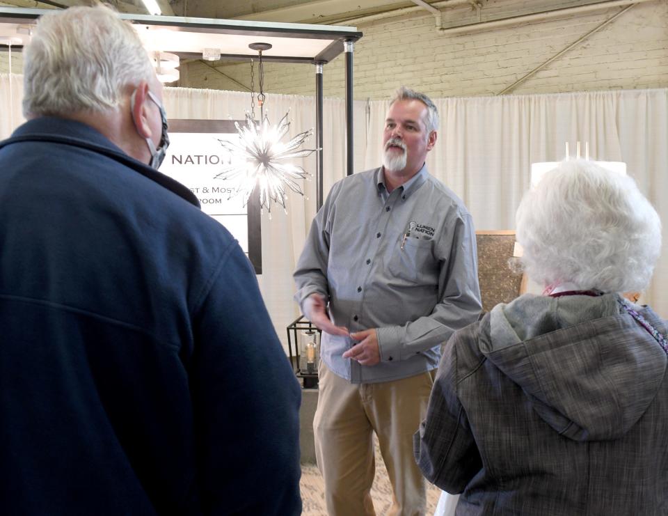 Tom Rafferty, owner of Lumen Nation, talks with visitors to the 2022 Stark County Home & Garden Show going on this weekend at the Stark County Fairgrounds.