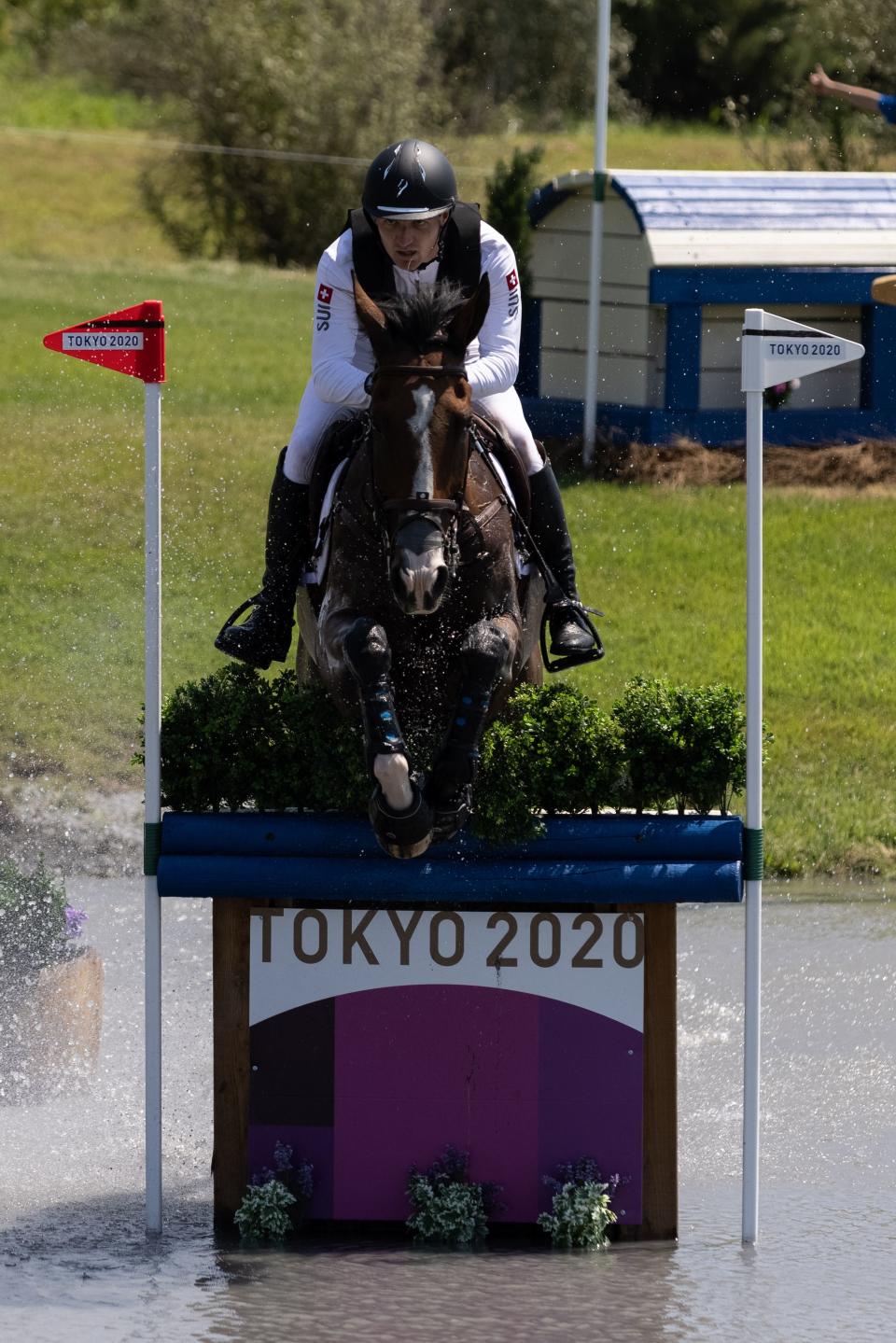 <p>Switzerland's Robin Godel riding Jet Set competes in the equestrian's eventing team and individual cross country during the Tokyo 2020 Olympic Games at the Sea Forest Cross Country Course in Tokyo on August 1, 2021. (Photo by Yuki IWAMURA / AFP) (Photo by YUKI IWAMURA/AFP via Getty Images)</p> 