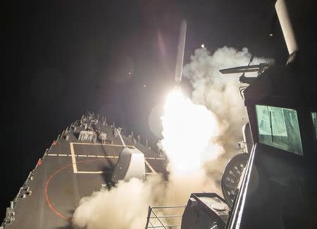 U.S. Navy guided-missile destroyer USS Ross (DDG 71) fires a tomahawk land attack missile in Mediterranean Sea which U.S. Defense Department said was a part of cruise missile strike against Syria on April 7, 2017. Robert S. Price/Courtesy U.S. Navy/Handout via REUTERS