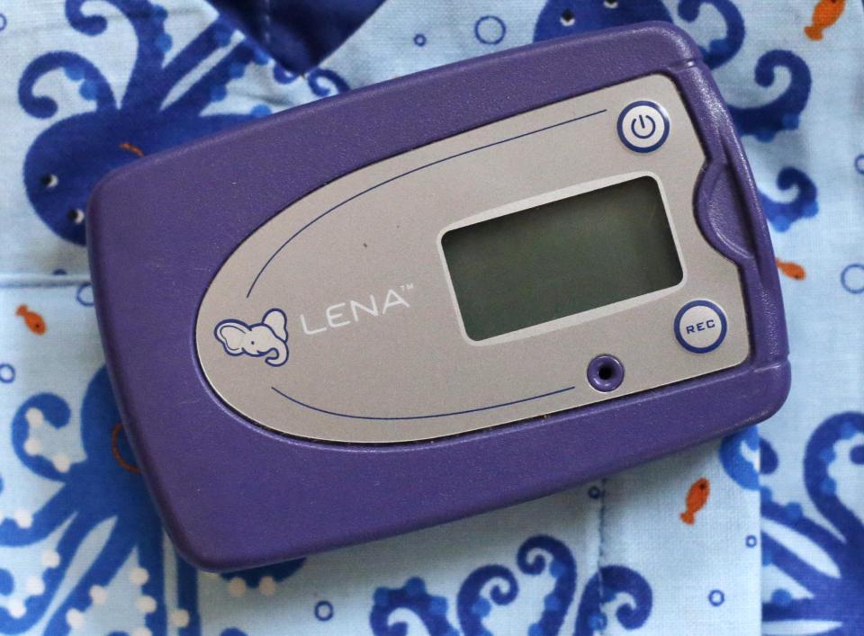 In this Feb. 3, 2014 photo, a digital audio recorder rests on a toddler's bib at a home in Providence, R.I. The city has begun an effort to boost language skills for children from low-income families by equipping them with audio recorders that count every word they hear. During home visits, social workers go over the word counts with parents and suggest tips to boost the child’s language skills. (AP Photo/Steven Senne)