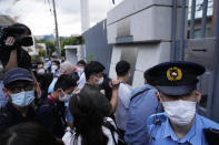 Journalists gather at the Poland Embassy to report on Belarusian athlete Krystsina Tsimanouskaya after she visited the embassy in Tokyo, Japan, Monday, Aug. 2, 2021. Tsimanouskaya, a Belarusian Olympic sprinter plans to seek asylum in Poland after alleging that officials tried to force her home, where she feared for her safety, an activist group said Monday. (AP Photo/Shuji Kajiyama)